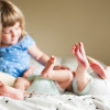 twins-newborns-sister-toddler-toes-detail